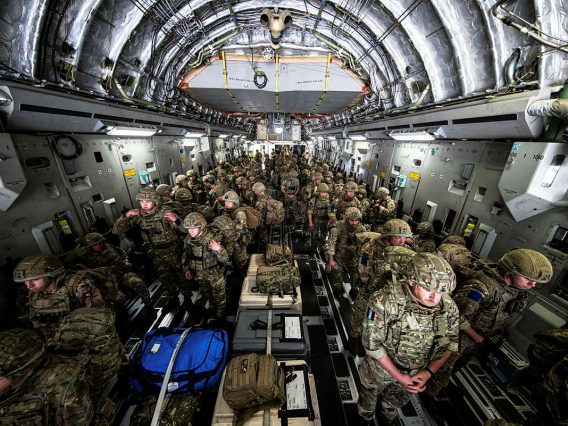 Image shows UK military personnel in a troop carrier aircraft
