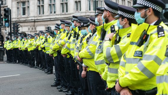 Image shows a line of police officers