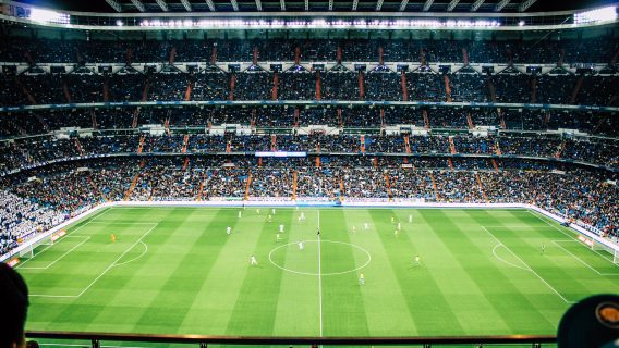 Image shows a football match in a stadium
