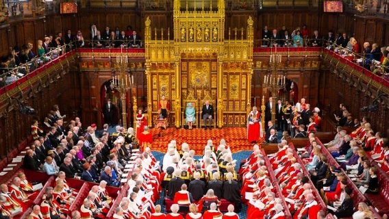 The Queen sits with the Prince of Wales at the December 2019 State Opening of Parliament in a packed chamber.