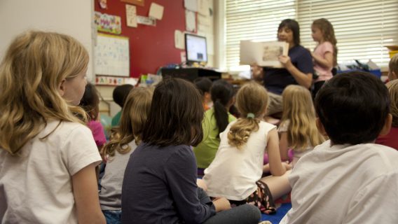 Cover image shows teacher teaching a class